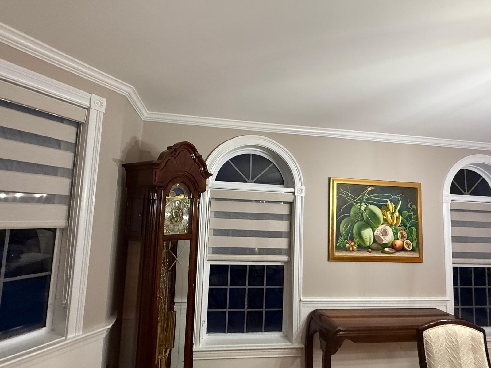 Living room windows with clean interior trim and crown molding