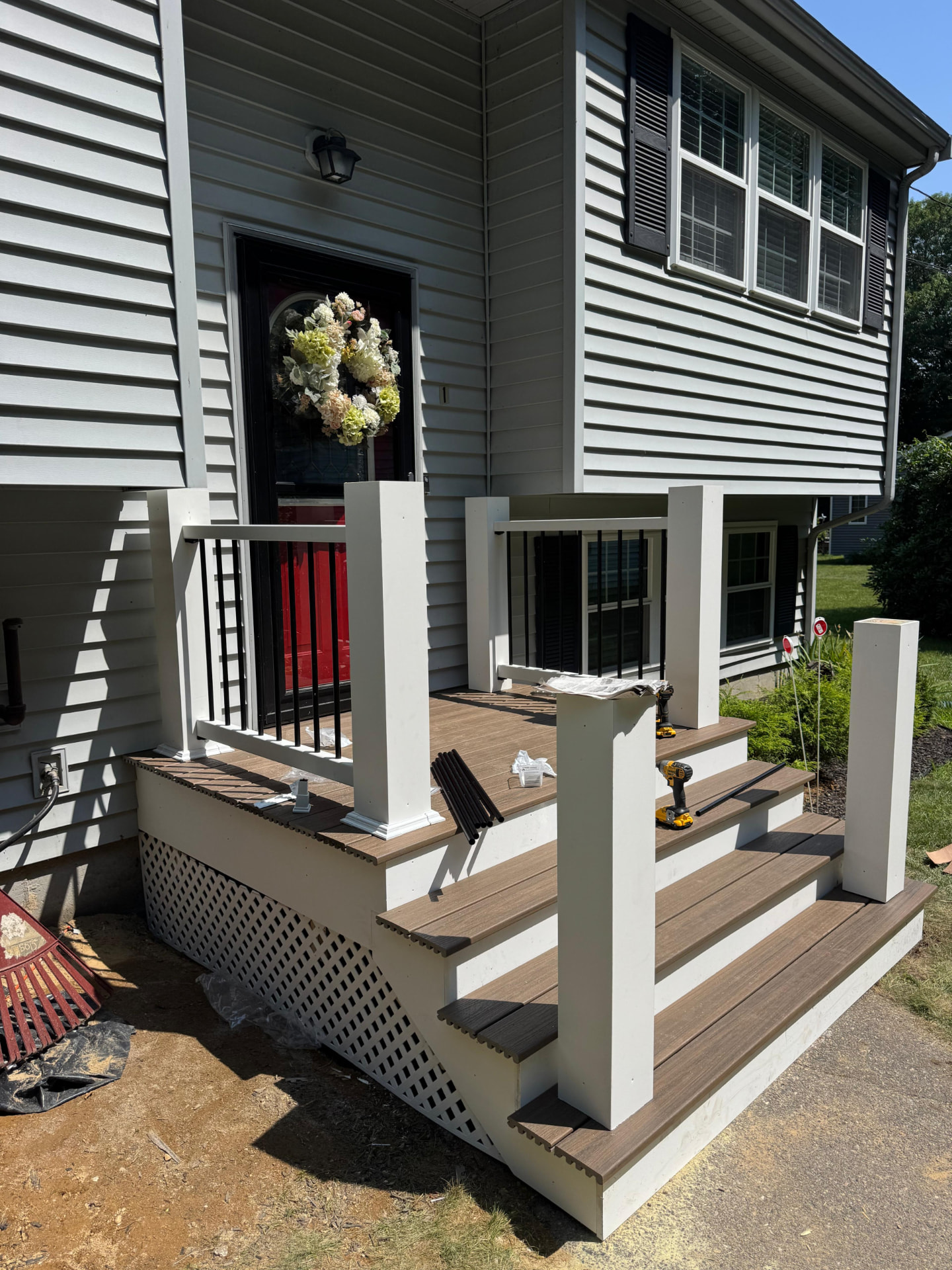 Front porch steps with decking, posts and lattice built by Betel Carpentry Inc