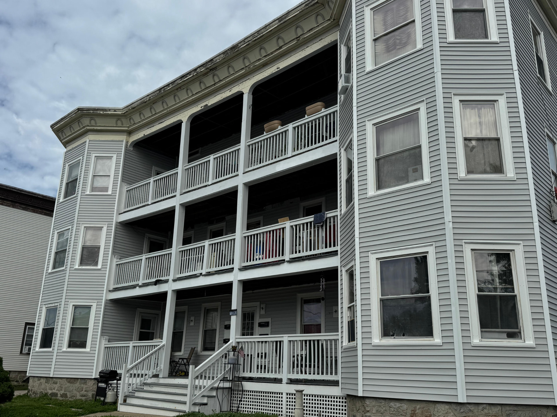 Multi-family building with porches, railings and exterior trim restored by Betel Carpentry Inc in Massachusetts